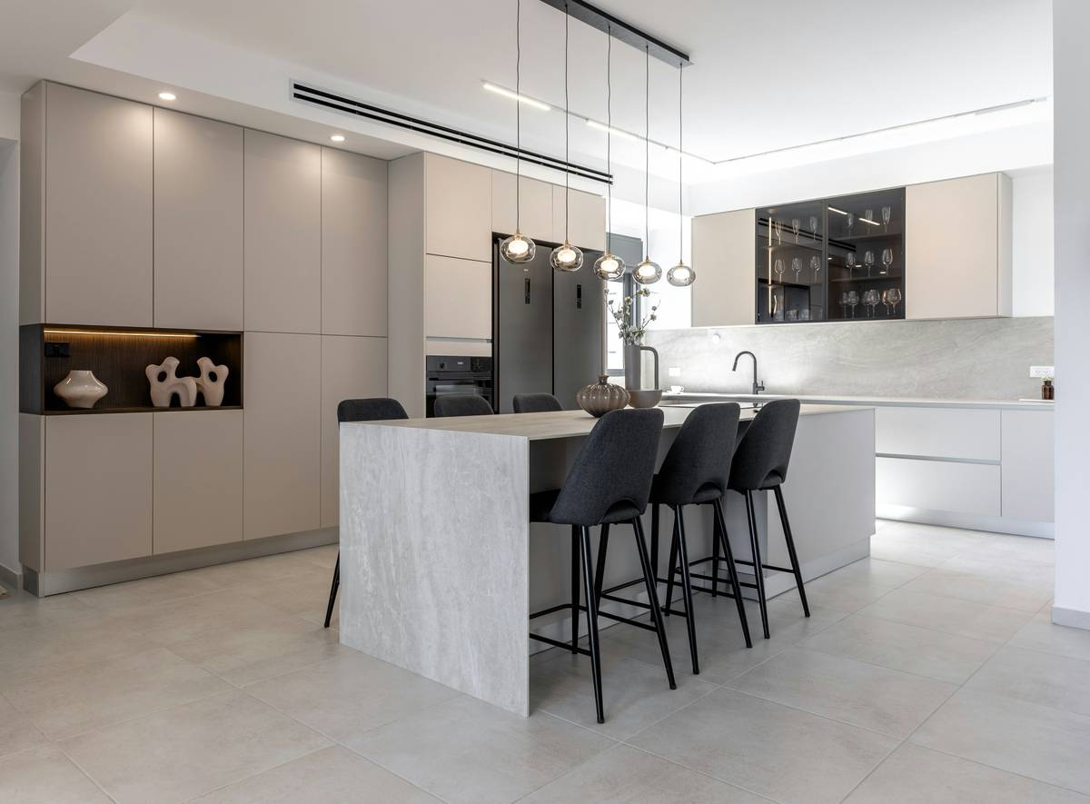 Modern bar stool style chairs at a kitchen island showing correct seat-to-countertop clearance