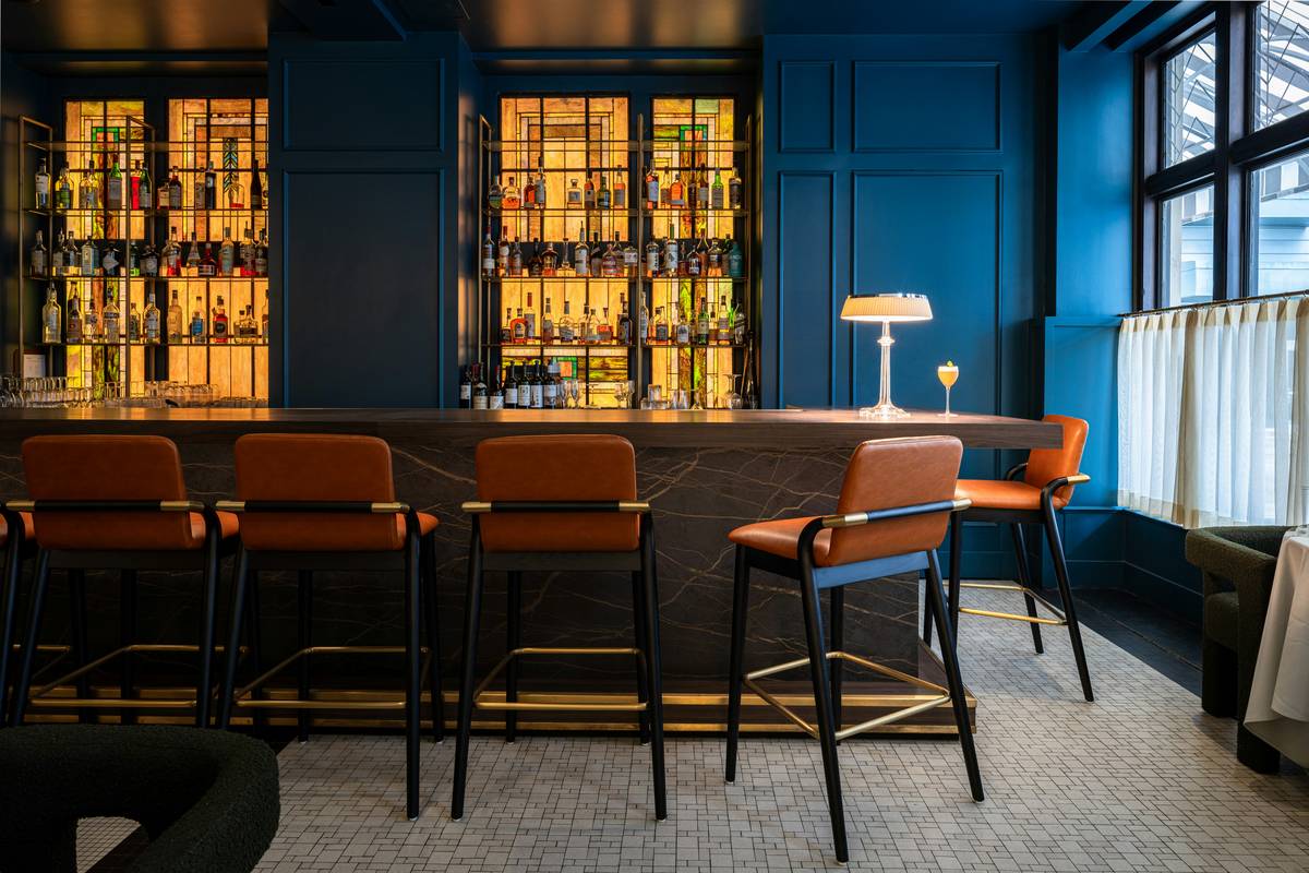 Modern bar stools for restaurants modern setup with brushed metal frames and upholstered seats in a busy urban eatery