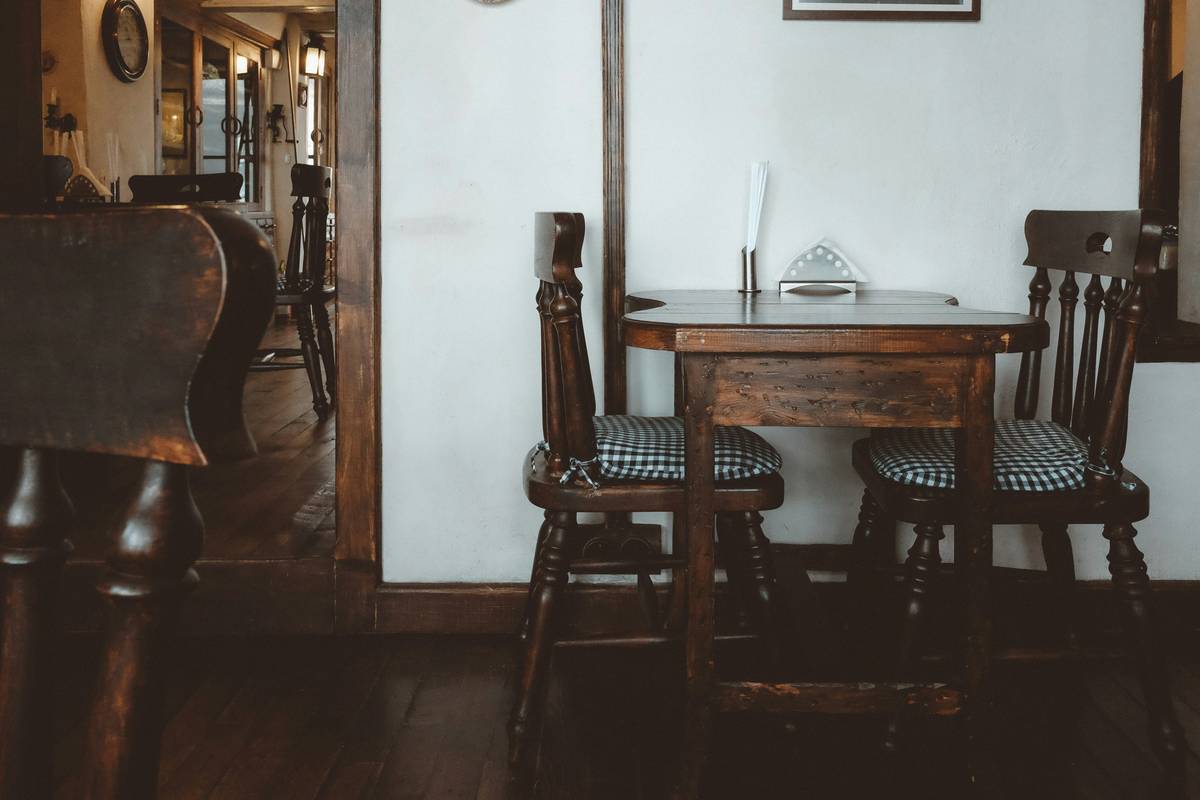 pub style table and bar stools with proper spacing and matching finishes in a modern kitchen